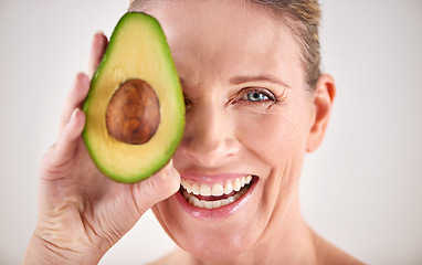 Image showing Happy, avocado and portrait of woman with skincare in studio for health, wellness or natural routine. Smile, beauty and mature person with organic fruit for dermatology treatment by white background.