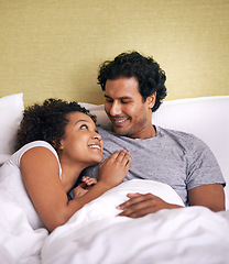 Image showing Bed, woman and man relax with smile, cuddle and rest on soft mattress, love and romance for couple. Partners, male person and girl in bedroom, happy and together in pyjamas, break and weekend