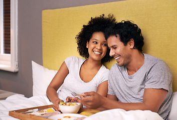 Image showing Couple, smile and bedroom for breakfast on tray for wakeup, morning and food for eat, rest and relax. Diverse and young people and laugh with happiness for bonding with fruit and bowl for joy