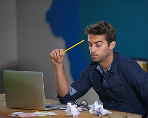 Image showing Crumpled, paper and man at laptop thinking for creative ideas, online research and brain fog in office. Brainstorming, computer and frustrated designer at desk with professional career at startup