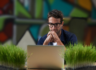 Image showing Glasses, reading and man at laptop thinking for creative solution, online research and ideas in office. Brainstorming, computer and designer at desk with professional career, business plan and vision