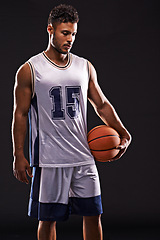 Image showing Man, sports and basketball player in studio for training, competition and fitness on black background. Professional athlete, career and exercise with ball for game, hobby and healthy model in mockup