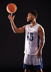 Image showing Man, finger and basketball player in studio as sports athlete for workout competition, training or black background. Male person, ball and exercise champion or professional, fitness or mockup space