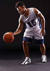 Image showing Man, playing and basketball player in studio for sports athlete for workout competition, training or black background. Male person, bounce and exercise performance or professional, fitness or mockup