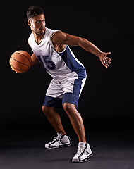Image showing Man, sport and basketball player in studio for fitness, competition and training on black background. Professional athlete, career and exercise with ball for game, hobby and healthy model in action