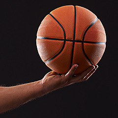 Image showing Hand, basketball and sports game in studio for player performance, exercise or black background. Person, training and workout competition for hobby practice as fit athlete, fitness or mockup space