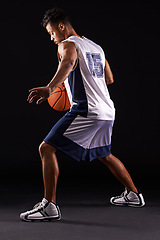 Image showing Man, action and basketball in studio for fitness, competition and sports player on black background. Professional athlete, career and exercise with ball for game, hobby and healthy model in training