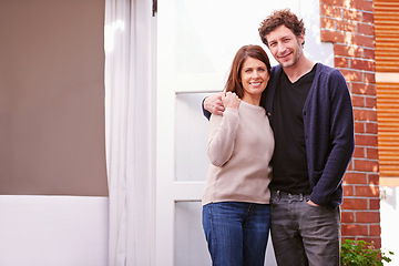 Image showing Happy, portrait of couple embracing by home for marriage, love and care holding hands. Smile, excited and mature man and woman hugging by door outdoor of new house for real estate or property.