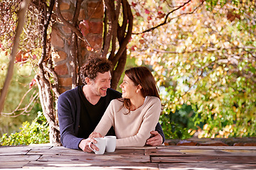 Image showing Spring, relax and couple embrace with coffee cups on table in nature, environment and together for romance. Partners, woman and man with hand from girl, hug and touch for love in marriage and park