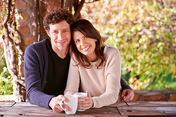 Image showing Portrait, coffee and couple in a backyard, hug and smile with love and nature with sunshine or morning tea. Face, embrace or cappuccino with happiness, woman or man with romance, marriage or vacation