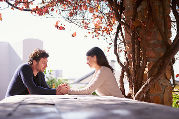 Image showing Outdoor, spring and couple holding hands on table in nature, environment and together for romance. Partners, woman and man with compassion from girl, care and touch for love in marriage and park