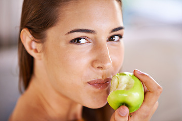 Image showing Woman, portrait and apple for nutrition in home, organic fiber and fruit for wellness. Happy female person, vitamins and minerals for healthy living, eating snack and vegan food in closeup for diet