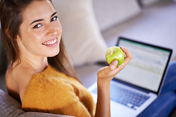 Image showing Woman, portrait and apple by laptop on couch, internet and nutrition while studying online. Person, student and university website for e learning, home and organic fruit for diet or minerals on app