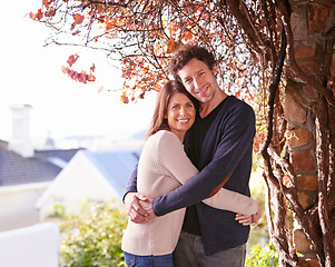 Image showing Smile, nature and portrait of couple hugging by tree in backyard garden at modern home. Happy, love and mature man and woman embracing with care in outdoor park or field for fresh air together.
