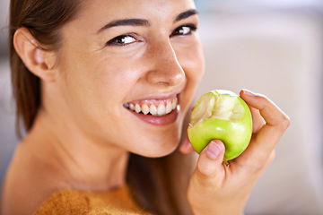 Image showing Woman, portrait and apple for hunger in home, organic fiber and fruit for wellness. Happy female person, vitamins and minerals for healthy living, eating snack and vegan food in closeup for diet