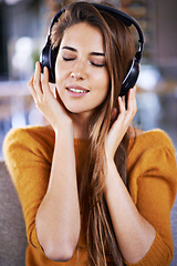 Image showing Woman, headphones and listening to audio on couch, relax and streaming radio for music or sound. Female person, home and chill on sofa for peace, comfortable and hearing jazz playlist on weekend