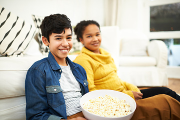 Image showing Happy family, love and popcorn in portrait in home and relax for bonding together on vacation. Brother, sister and positive face of siblings by couch, floor and snack on school holiday in living room