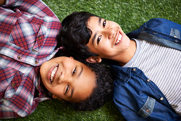 Image showing Children, brother and sister on lawn, above and portrait with smile, bonding and relax in backyard at family home. Kids, boy and girl with sibling for care, love and connection on vacation on grass