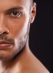 Image showing Skincare, man and half portrait in studio zoom for wellness, dermatology or skin cleaning on black background. Face, water and male model with masculine beauty, cosmetics or facial splash treatment