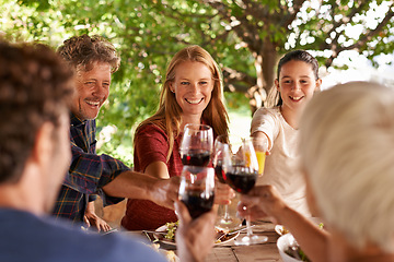 Image showing Family, lunch and cheers with happiness, celebration and bonding together with joy and weekend break. Group, generations and parents with girl and daughter with food and drinks with meal and relaxing