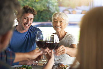 Image showing Family, lunch and cheers with wine, celebration and bonding together with joy and weekend break. Group, generations and smile with food or alcohol with meal or relaxing with love and social gathering