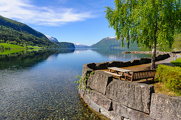 Image showing Serene picnic spot by pristine lake in norwegian mountains, spri