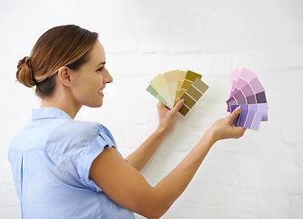 Image showing Color sample, wall and woman in house for interior design or renovation project and swatches for paint decision or options. Person, remodeling and diy for home improvement or creativity and upgrade