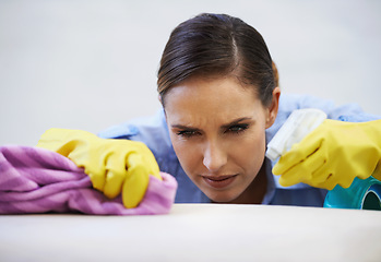 Image showing Woman, gloves and spray for cleaning table in home, disinfection and remove dirt or bacteria and dust. Female person, housekeeeping and wash with detergent or sanitation, maid and chemical for germs