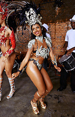 Image showing Women, samba dancer and smile at carnival, stage and band with fashion, culture and creativity in nightclub. Girl, people and dancing with music, drums and tradition for celebration in Rio de Janeiro