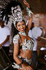 Image showing Dancer, samba and woman with festival, smile and makeup for concert or party. Brazilian performer, celebration and feather for culture, talent and creative artist for rio de janeiro carnival event