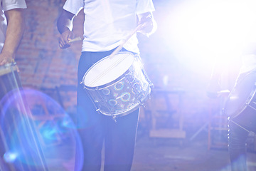 Image showing Music, male drummer and entertainment or performance, show and musician in band. Concert, dark or celebration for musical artist, percussion instrument and creative talent or acoustic with lens flare