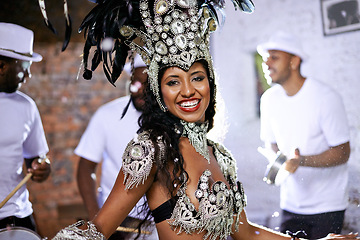 Image showing Portrait, happy woman and dancing at carnival with band for performance, party or celebration. Face, samba and Brazilian person at music festival in feather costume, makeup and smile at concert event