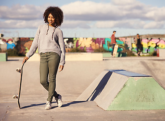 Image showing Portrait, fashion and black woman for exercise, hobby and skating in park with skateboard in city. Skater, fitness and face of female person for trendy, edgy and hipster clothing in urban town