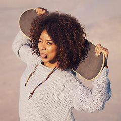 Image showing Portrait, funny and woman with skateboard in city in summer for sport, exercise or leisure outdoor. Tongue out, face and person wink at skate park in casual clothes for trendy fashion in South Africa