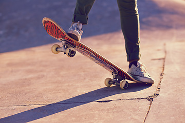 Image showing Skateboard, sneaker and person in skatepark for skate, recreation and active for game with wheels. Speed, move and performing for trick, sports and action on ground for toy and balance in summer