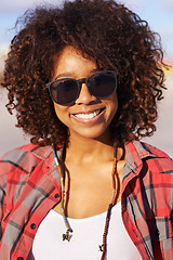 Image showing Fashion, portrait and black woman with sunglasses for trendy, edgy and hipster clothing in city of San Francisco. Smile, afro and face of female person for style, eyewear and confidence in park