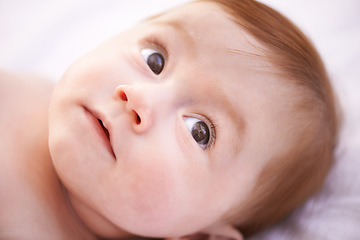 Image showing Closeup, girl and baby on bed with thinking for childhood development, growth and relax in nursery. Ginger, newborn and kid with wonder for wellness, curiosity or waking up in bedroom from above