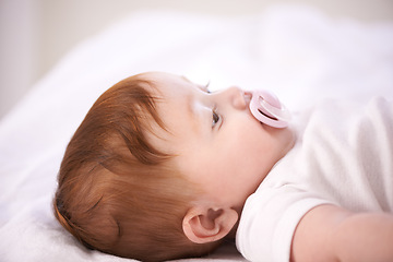 Image showing Baby, pacifier and relax on bed in home for with wellness, quiet and rest in morning in nursery. Infant, newborn and peace with soother, growth and closeup for childhood development in family house