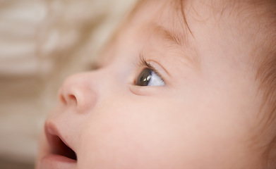 Image showing Newborn, closeup and baby with thinking for curiosity, childhood development and growth in bedroom. Adorable, healthy kid and cute infant with smile to relax, wonder or waking up in nursery at home