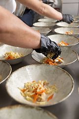 Image showing Professional chef plating food