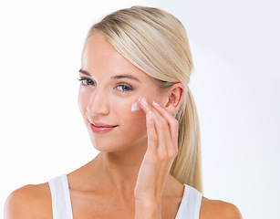 Image showing Woman, portrait and skincare lotion in studio or moisturizer wellness with dermatology, product or white background. Female person, cream and facial sunscreen or self care, protection or mockup space