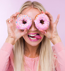 Image showing Donut, silly and portrait in studio for dessert, frosting and pink for sprinkles and sweet for sugar and crazy. Young person with tongue out for funny, comic and pastry for cake and icing for color