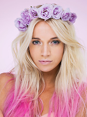 Image showing Woman, flower crown and beauty with studio portrait for makeup, cosmetics and spring by purple background. Girl, person or model with floral decoration, headband and style for aesthetic with wellness