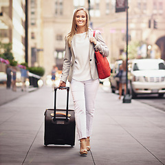 Image showing Business woman, baggage and portrait on urban sidewalk with smile, journey and outdoor with pride. Person, happy and luggage on travel in city on metro street by skyscraper buildings in New York