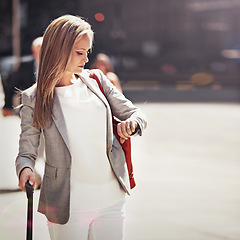 Image showing Business, woman and suitcase with watch for travel time management for airplane trip, downtown or city street. Female person, luggage and corporate professional for urban commute, hotel or meeting