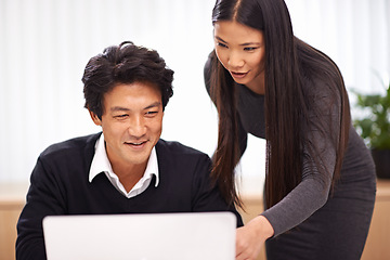 Image showing Help, mentor and teamwork on laptop in office with businessman learning from support of woman. Feedback, advice and manager training asian man on computer in collaboration and reading online research