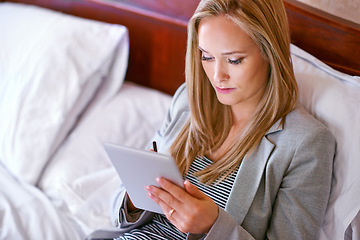Image showing Business woman, tablet and hotel room with travel and reading for attorney case with brief. Technology, bed and hospitality with digital, web reading and planning of a law professional on a trip