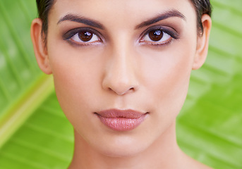 Image showing Face, woman and beauty with palm leaf background, makeup and natural skincare with dermatology. Organic, nature and eco friendly cosmetics in portrait, clean with wellness and sustainable treatment