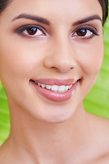 Image showing Face, happy woman and beauty with palm leaf background, makeup and natural skincare with dermatology. Organic, nature and eco cosmetics in portrait, clean with wellness and sustainable treatment