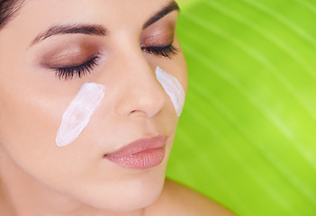 Image showing Cream, closeup of woman and beauty with palm leaf background, moisturizer and natural skincare for dermatology. Organic, nature and eco cosmetics with lotion, eyeshadow with sustainable facial